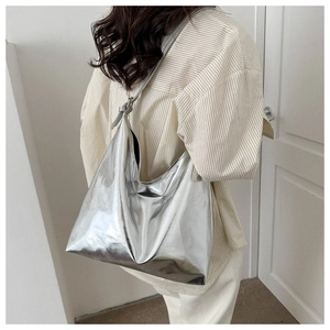 Detailed close-up of metallic silver hobo bag showing high-gloss leather texture