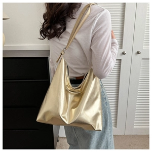 Detailed view of champagne gold metallic tote bag with soft texture and slouchy design