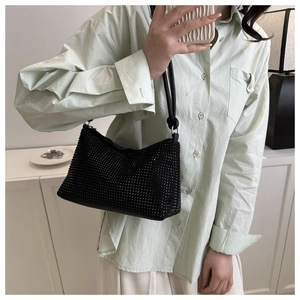 Detailed view of black rhinestone hobo bag with knotted leather shoulder strap