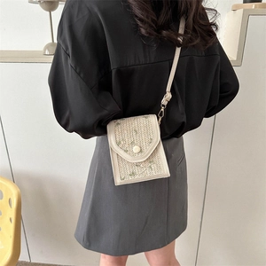 Minimalist beige woven crossbody bag with green floral embroidery for spring fashion