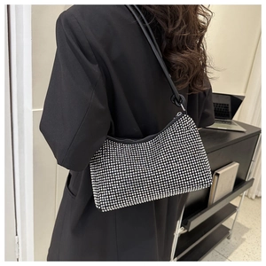 Detail view of stylish black underarm bag with shimmering silver rhinestones and zipper