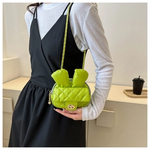 Close-up of a neon green quilted crossbody bag with cute rabbit ears and gold chain