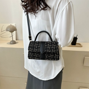 Classic black and white tweed crossbody bag with leather trim and gold hardware details