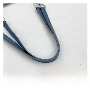 Detail of blue leather shoulder strap with reinforced stitching and silver ring hardware