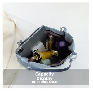 Detail showing high-capacity blue tote bag interior with tablet and daily essentials