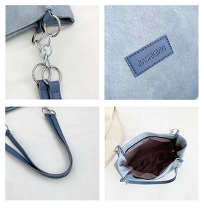 Detailed close-up of blue tote bag showing silver metal hardware and internal pocket lining