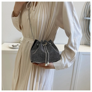 Detail of black drawstring bucket bag with shiny rhinestones and pearl chain accents