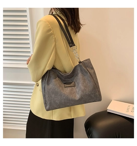 Detail of grey vintage matte tote bag with silver chain strap and wide shoulder belt