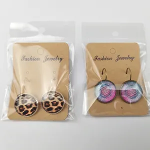 Leopard print and floral glass dome earrings with bronze hooks on fashion jewelry card