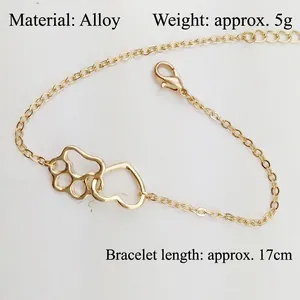 Eco-friendly golden alloy bracelet featuring hollow heart and paw print charms