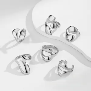 Detail shot of six minimalist liquid metal rings with a polished silver finish