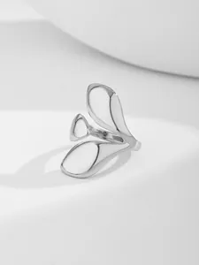 Detailed view of silver fashion nail ring with asymmetric fluid petal design
