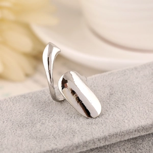 Macro side view of polished silver nail ring showing glossy finish and open-back structure