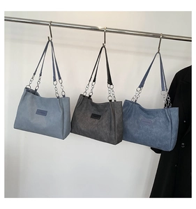 Three large capacity tote bags in light blue, black and blue with metal chain straps