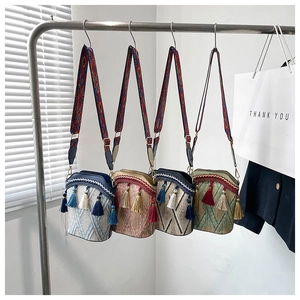 Detailed view of bohemian woven bucket bags with tassel charms and ethnic embroidery straps