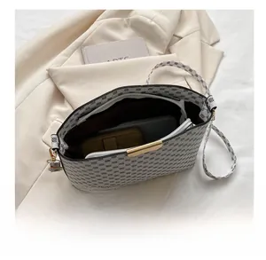 Detail showing the large interior capacity of this patterned white crossbody square bag