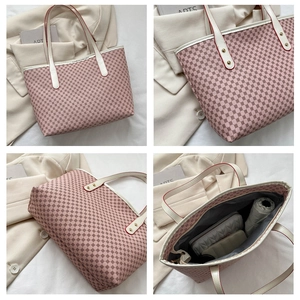 Detail view of pink tote bag with geometric patterns, white leather handles and large capacity