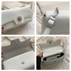 Detail view of white PU leather crossbody bag featuring magnetic closure and inner storage