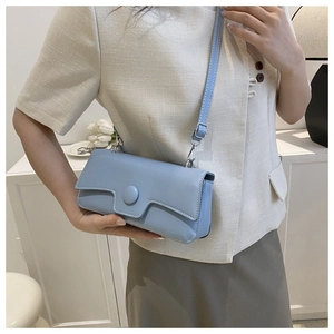 Light blue crossbody bag showing aesthetic fit on beige blazer outfit for women