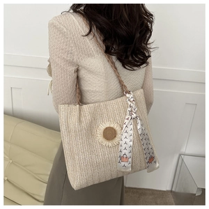 Détail du sac cabas en paille beige avec fleur de tournesol 3D et foulard en soie au manche