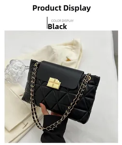 Detail of black quilted leather handbag with gold chain strap and square buckle