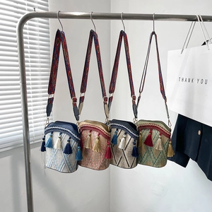 Bohemian style straw bucket bags with colorful tassels and geometric straps for summer