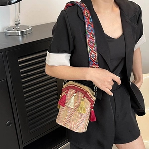 Ethnic boho bucket bag with colorful woven strap and silk tassels for women's casual style