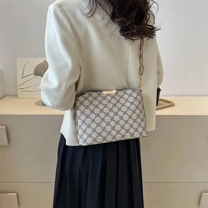 Classic monogram crossbody bag with gold metal trim and leather strap for women