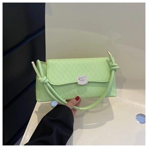 Detail of light green quilted shoulder bag with silver clasp and knot strap detail