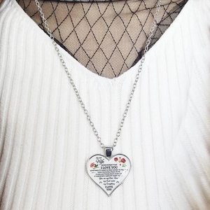 Detailed close-up of heart pendant necklace with red rose and loving message for wife