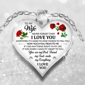 Close-up of heart pendant necklace with red rose and loving message for daughter