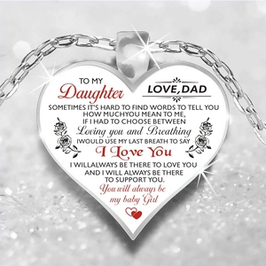Detailed macro shot of heart pendant necklace with sentimental message for daughter