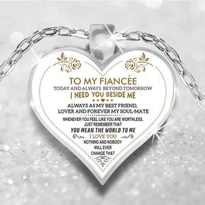 Detailed view of silver heart pendant for fiancée with romantic message and floral patterns