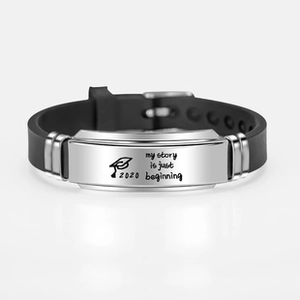Detail of engraved 2020 graduation silicone bracelet with my story is just beginning text