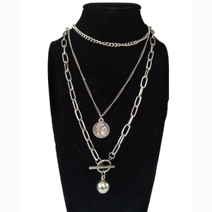 Three-layer silver hip-hop necklace with coin pendant and toggle clasp on display