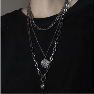 Three-layer silver chain necklace with vintage coin and ball pendants on black fabric