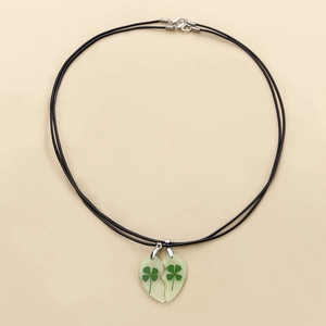 Luminous heart matching necklaces with real dried four leaf clover specimens for couples