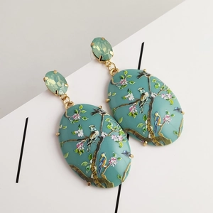 Elegant gold oval earrings with hummingbird floral print and light green crystals