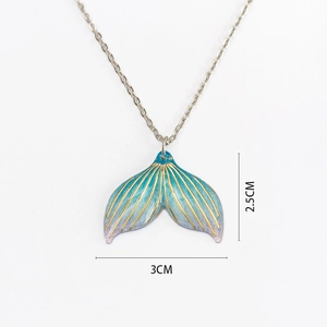 Detail showing mermaid tail pendant size of 3cm x 2.5cm with blue gradient finish