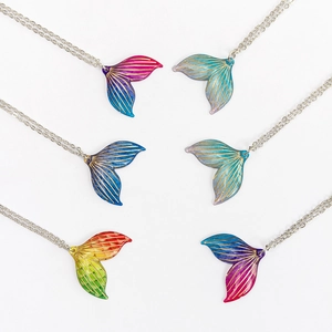 Showcase of six gradient acrylic mermaid tail pendants with fine golden textures
