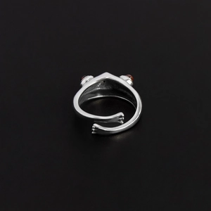 Adjustable silver-tone frog ring with red gemstone eyes and wrap-around animal design