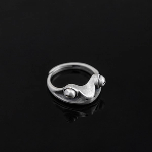 Detailed close-up of vintage frog ring with matte silver finish and open adjustable band