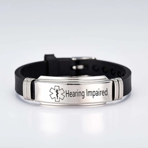 Detail view of black silicone medical alert bracelet with Hearing Impaired engraving