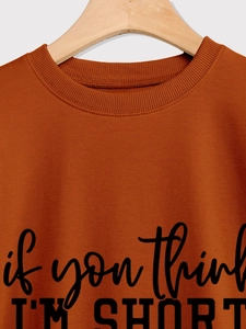 Close-up of caramel sweatshirt neckline with 'if you think I'M SHORT' slogan print