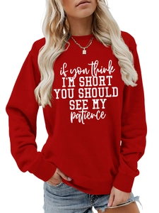 Close-up of funny quote print on vibrant red cotton sweatshirt with ribbed cuffs