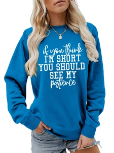 Detail of royal blue sweatshirt rib-knit neckline and white printed text slogan