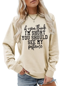 Detail of letter print on apricot crew neck sweatshirt with ribbed collar and cuffs