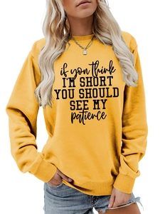 Detailed close-up of ribbed cuffs and text print on bright yellow sweatshirt