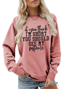 Detail of pink crewneck sweatshirt with 'if you think I'M SHORT' slogan print