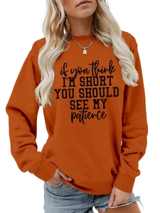 Detail showing high-quality slogan print and ribbed cuffs on orange sweatshirt